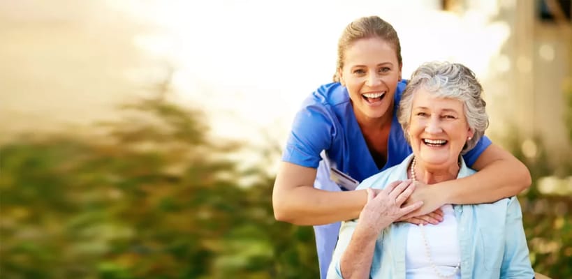 A caregiver and a resident enjoying time outdoors