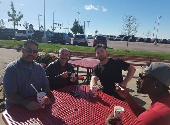 Residents enjoying ice cream outdoors at a picnic table