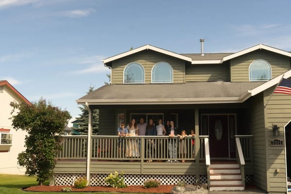 Group of people on a porch of a facility
