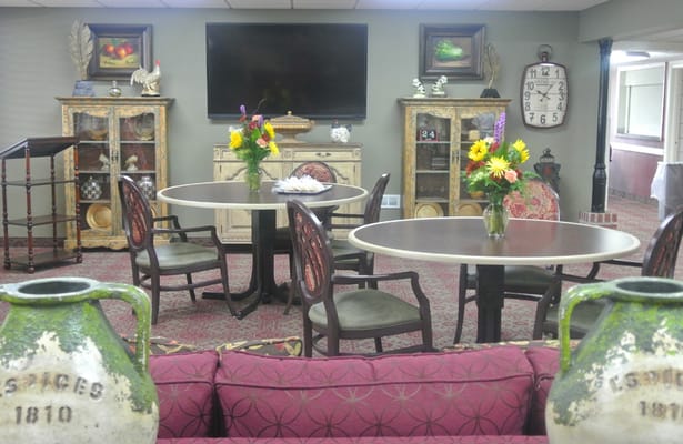 Common area with tables and floral arrangements