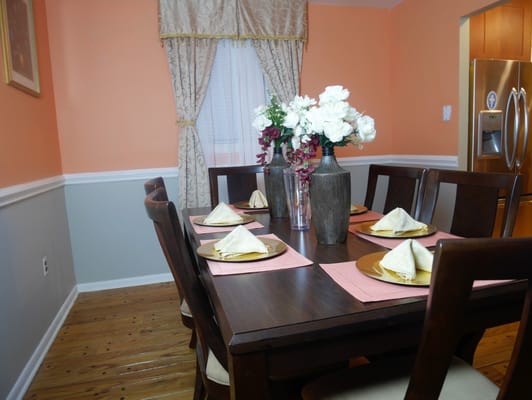 Dining area with a wooden table set for a meal