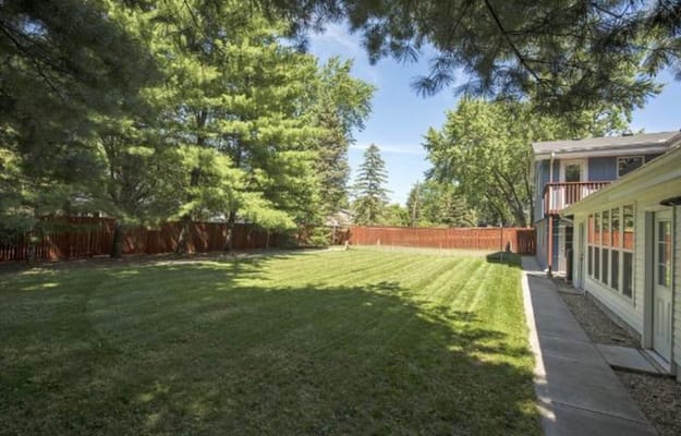 Well-maintained outdoor space with grass and trees