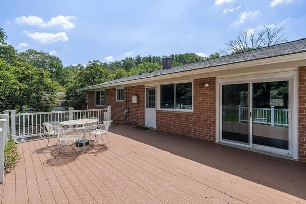 Spacious deck area with seating and a view of the surroundings