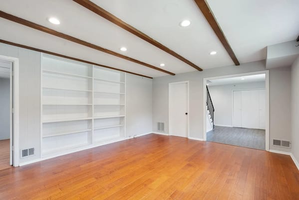 Bright living room with wooden floors and built-in shelves