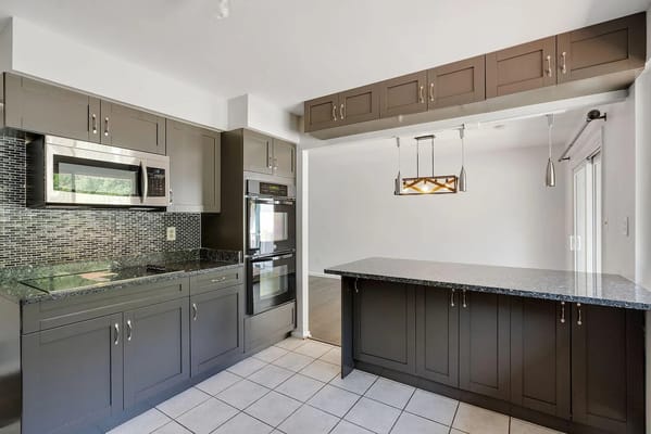Spacious kitchen with modern appliances and granite countertops