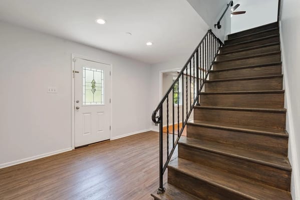 Bright entryway with a staircase and front door