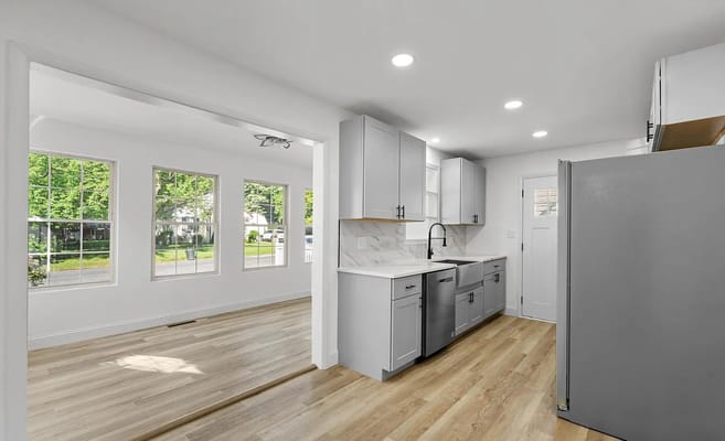 Modern kitchen featuring gray cabinets and stainless steel appliances.