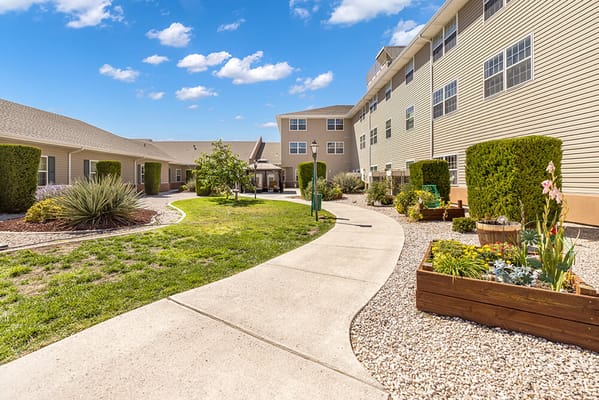 Pathway through a landscaped outdoor area of the facility