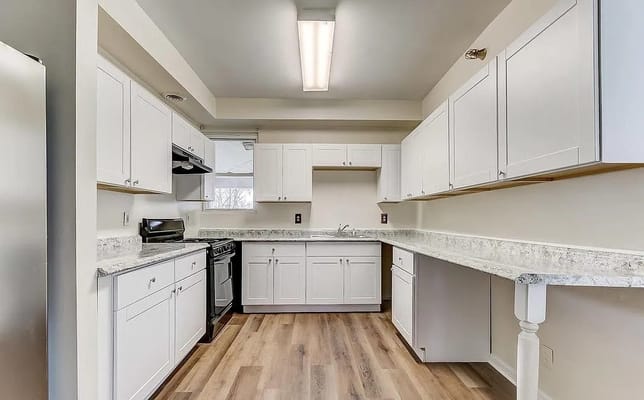 Bright and modern kitchen with white cabinets and granite countertops