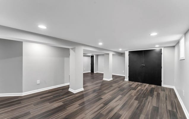 Empty lounge area with wooden flooring and gray walls