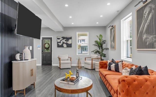 Bright living room with orange couch and modern decor