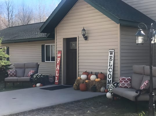 Front entrance decorated with fall-themed decorations, including pumpkins and a 'Welcome' sign.