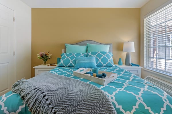 Cozy bedroom setup with turquoise bedding and decor