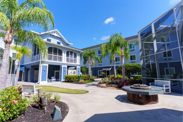 Bright outdoor courtyard with seating and palm trees