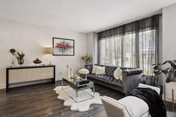 A stylish and inviting living room with a grey couch, coffee table, and decorative elements.