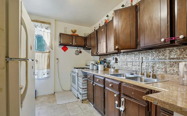 Cozy kitchen area with wooden cabinets and appliances