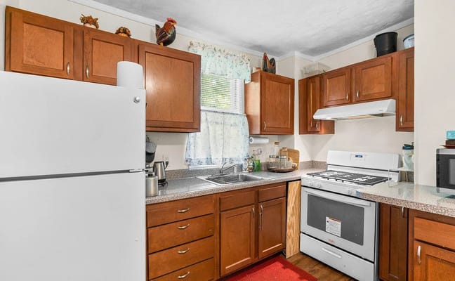 Warm kitchen space with wooden cabinets and appliances