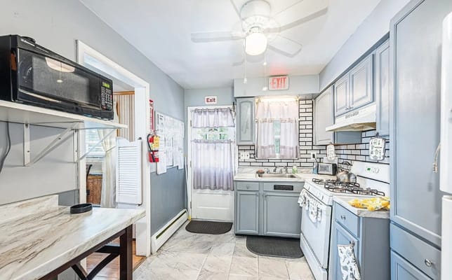Bright kitchen with blue cabinets and modern appliances