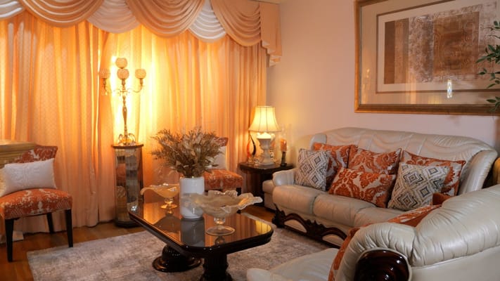 Cozy living room with cream-colored furniture and warm lighting