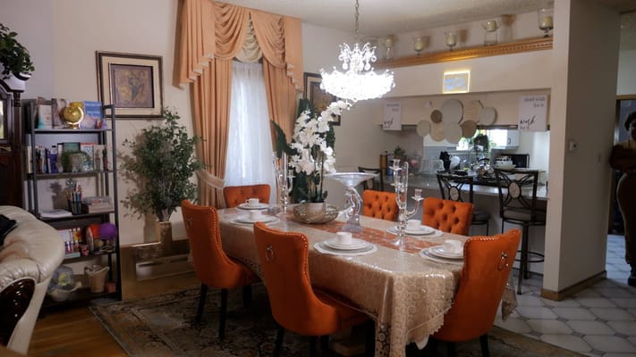 Elegant dining room with a large table and orange chairs