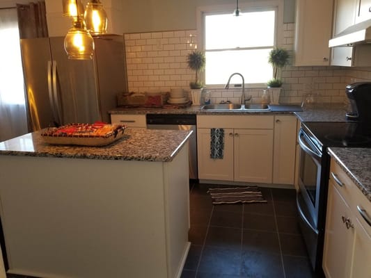 Bright and spacious kitchen with granite countertops and stainless steel appliances