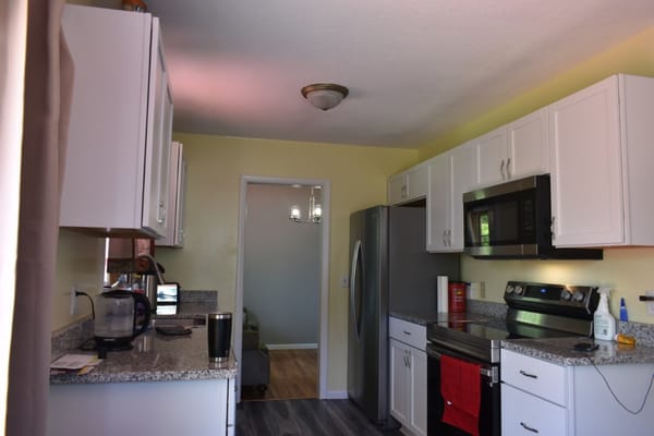 Modern kitchen with white cabinets and stainless steel appliances