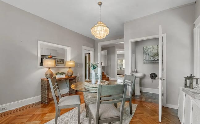 Cozy dining area featuring a round glass table and stylish lighting
