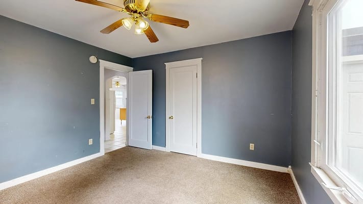 Interior view of a room with beige carpet and blue walls