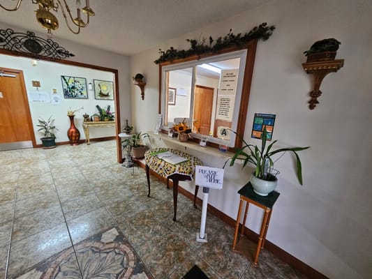 Welcoming lobby area with plants and artwork