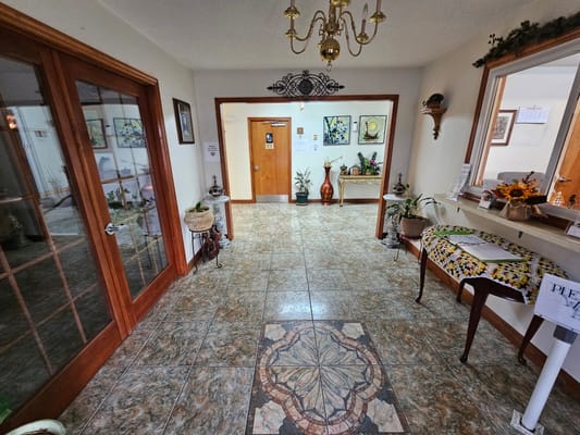 Entrance hall featuring tiled floor and decorative plants