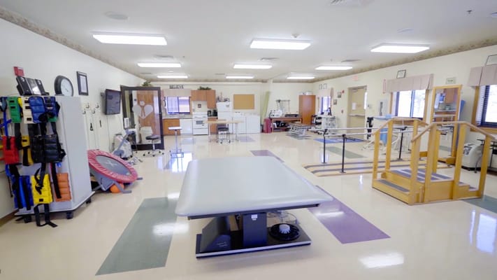 Spacious therapy room with various rehabilitation equipment