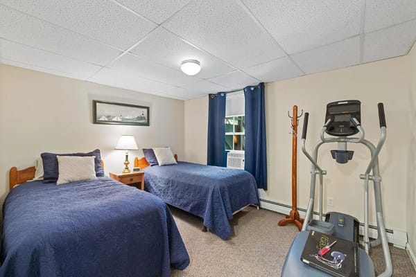 Shared room featuring two beds and exercise equipment