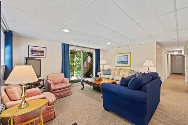 Comfortable living room with sofas and a view of the outdoor patio.