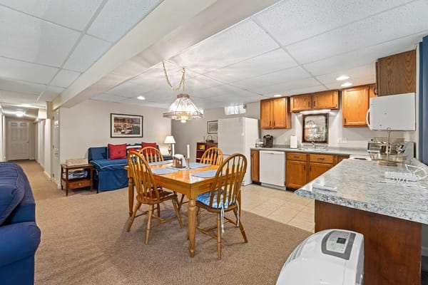 Cozy kitchen and dining area featuring wooden furniture and appliances