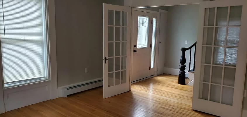 Entrance area with glass door and wooden staircase