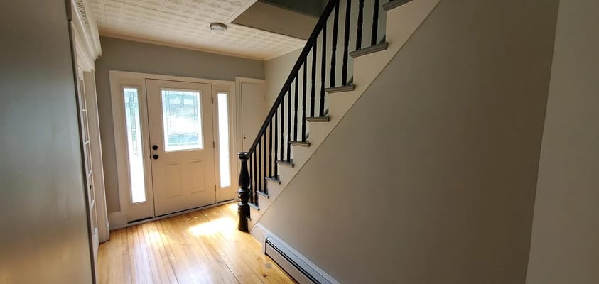 Bright entryway with stairs and front door