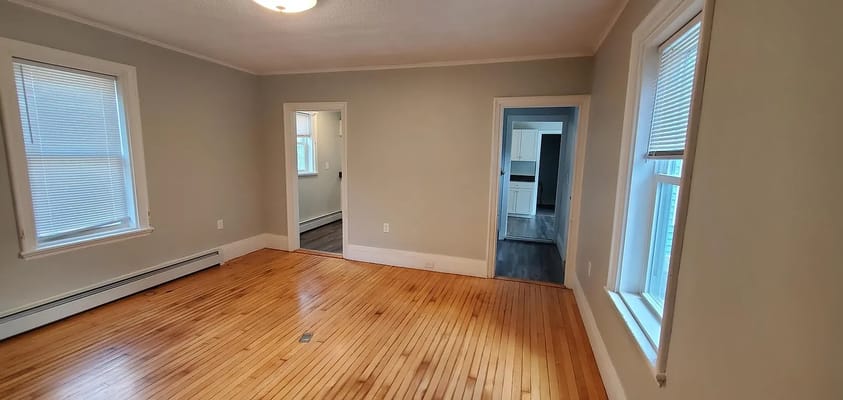 Bright living room with hardwood flooring and windows