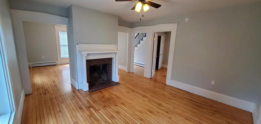Living room with hardwood floors and a fireplace