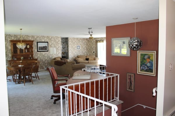 Cozy living area with a dining table, seating, and decorative wall.