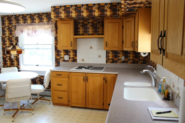 Bright and spacious kitchen with wooden cabinets and dining area.