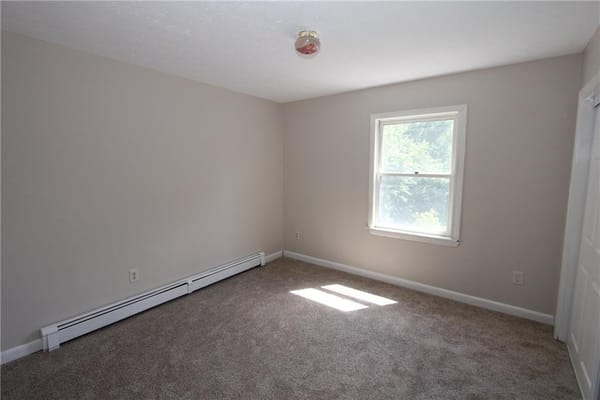 Bright room with window and carpeted floor