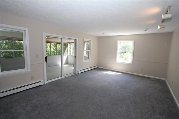 Spacious living room with carpet and large windows