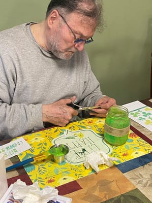 Resident engaged in a creative activity at a table