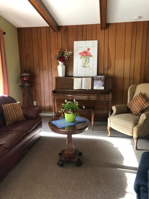 Cozy common area with a piano and seating