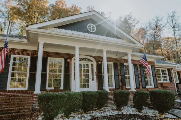 Exterior view of the facility with flags and entrance