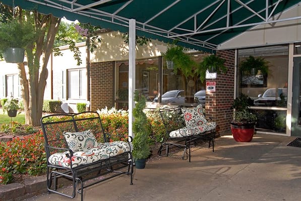 Outdoor seating area with lush greenery