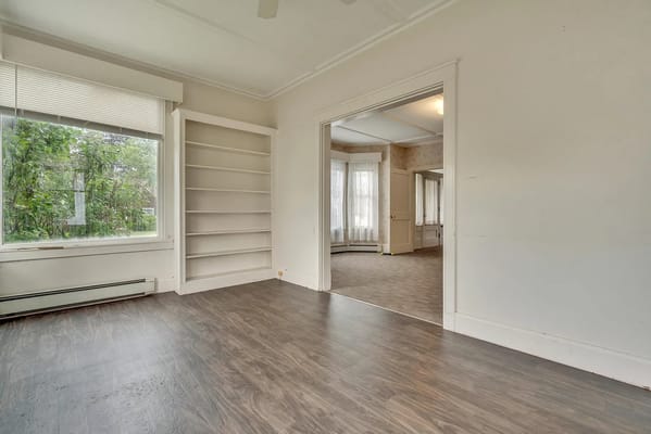 Bright living room with large window and built-in shelves