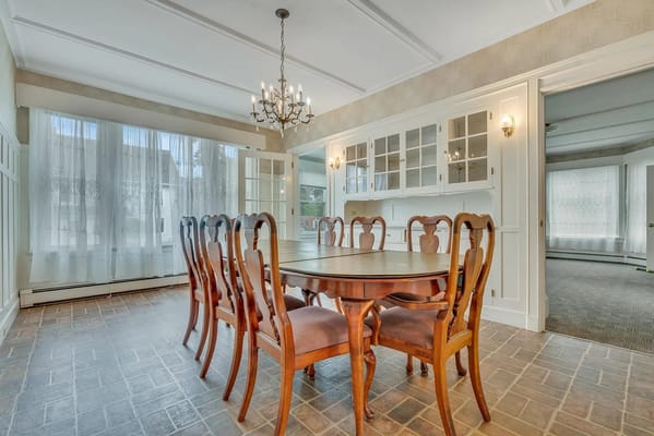 Spacious dining room with wooden table and chairs