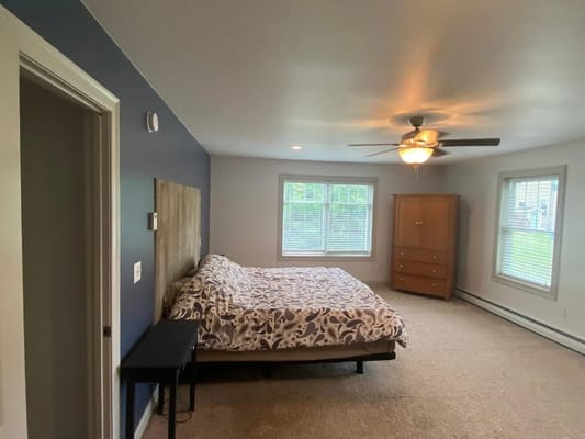 Spacious bedroom with a queen bed and dresser