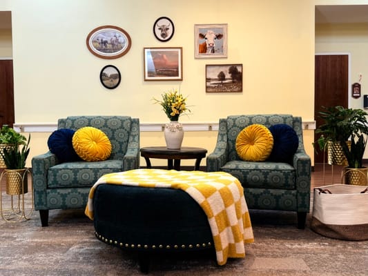 Cozy lobby area with chairs and decorative wall art